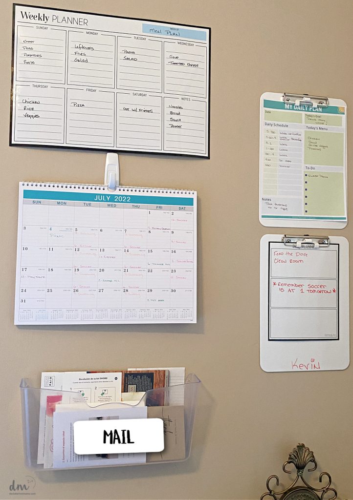 wall command center in a home with calendars and clipboards 