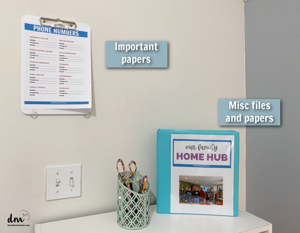 a clipboard on the wall and a home hub binder on a table