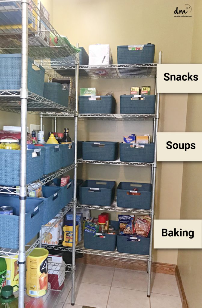 a walk in pantry with metal shelves and blue labled baskets