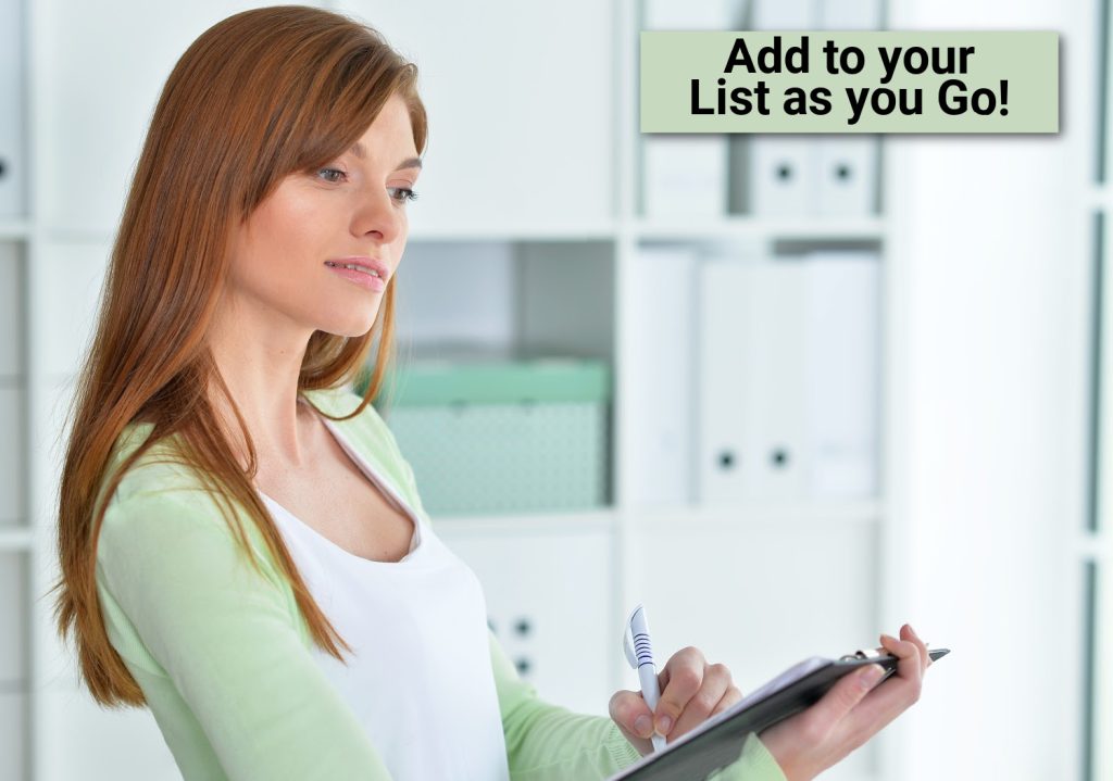 a woman in a green sweater writing on a clipboard