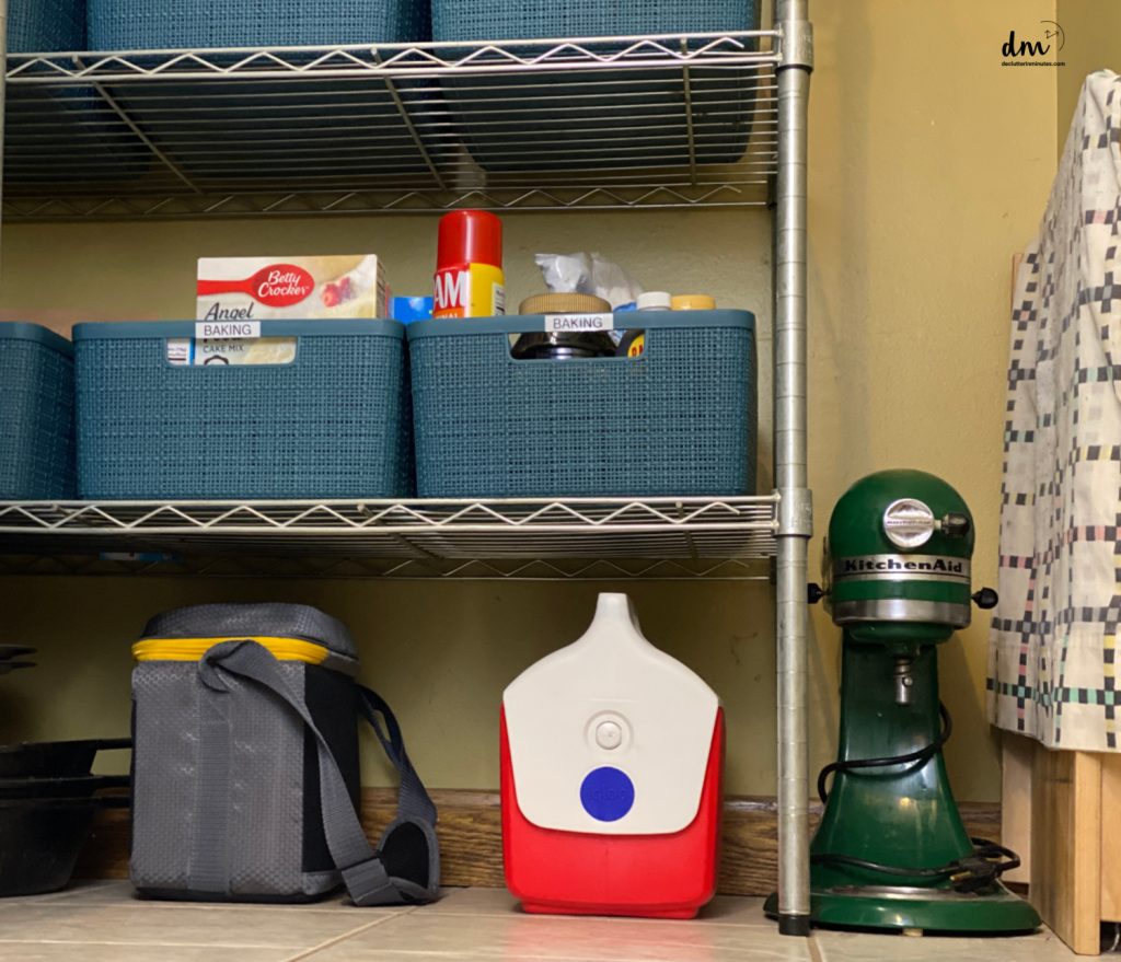 baking supplies in blue bins on a metal shelf
