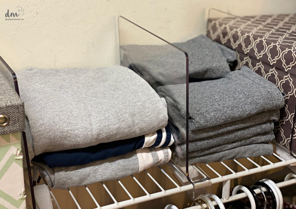 shelf dividers holding sweats in a closet