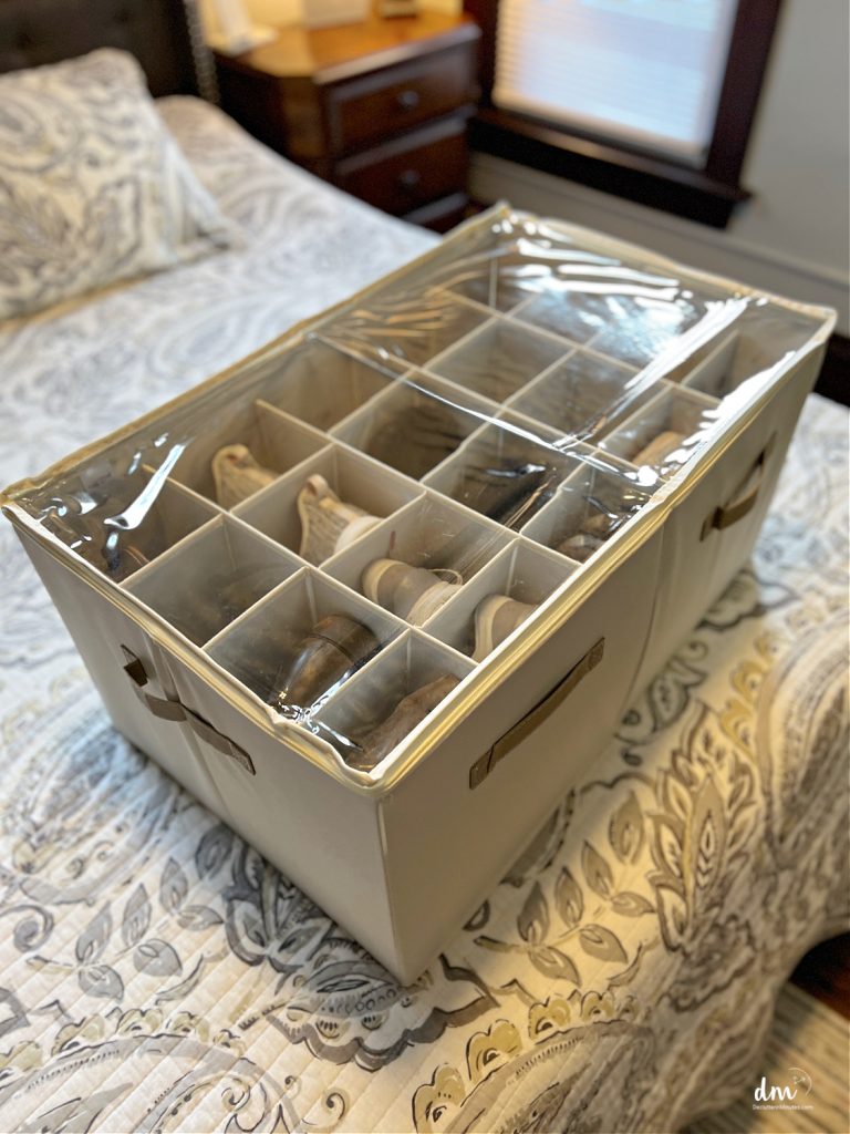 shoes inside of a cube organizer on a bed