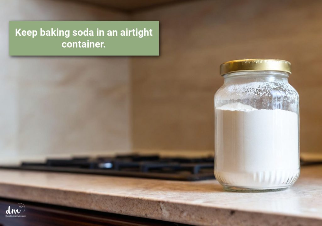 a glass jar filled with baking soda sitting next to a stove top