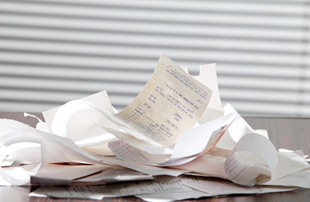 a stack of receipts on a kitchen counter 