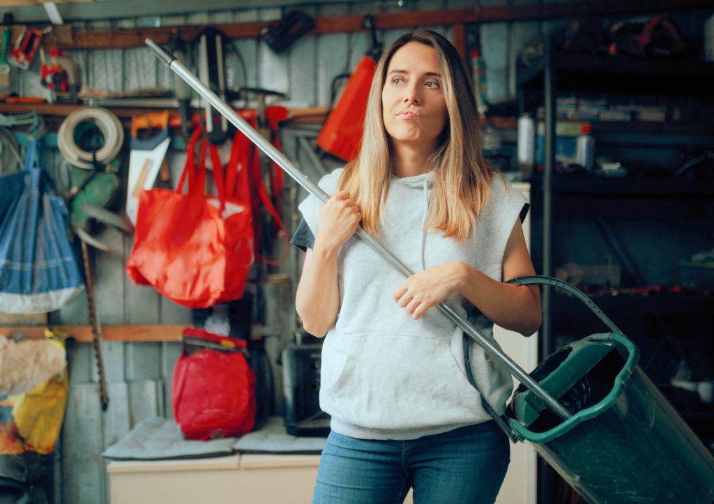 a woman prepare to clean a messy garage