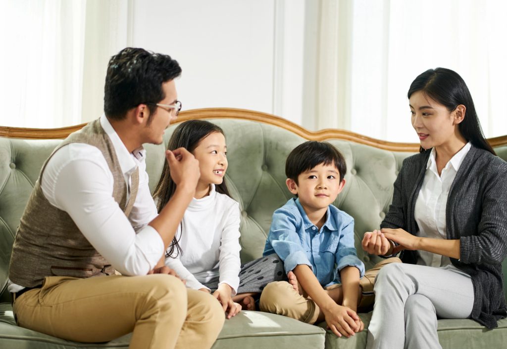 a young family talking on a couch