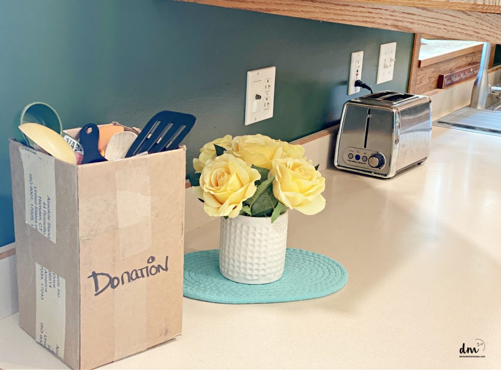 a brown box labeled donation sitting on a kitchen counter