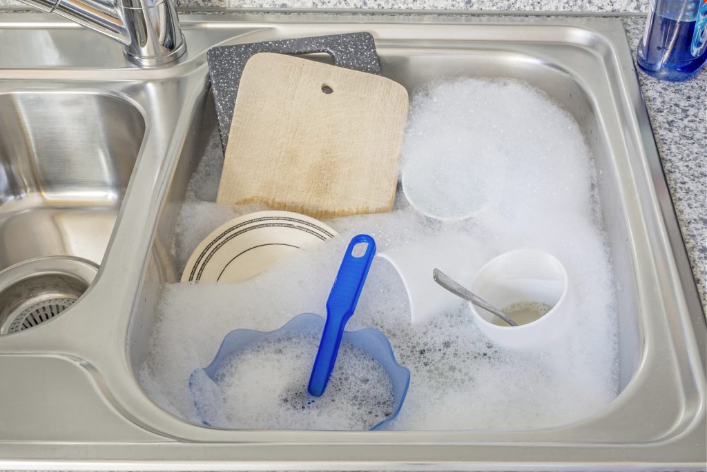 a sink of soapy water filled with dishes