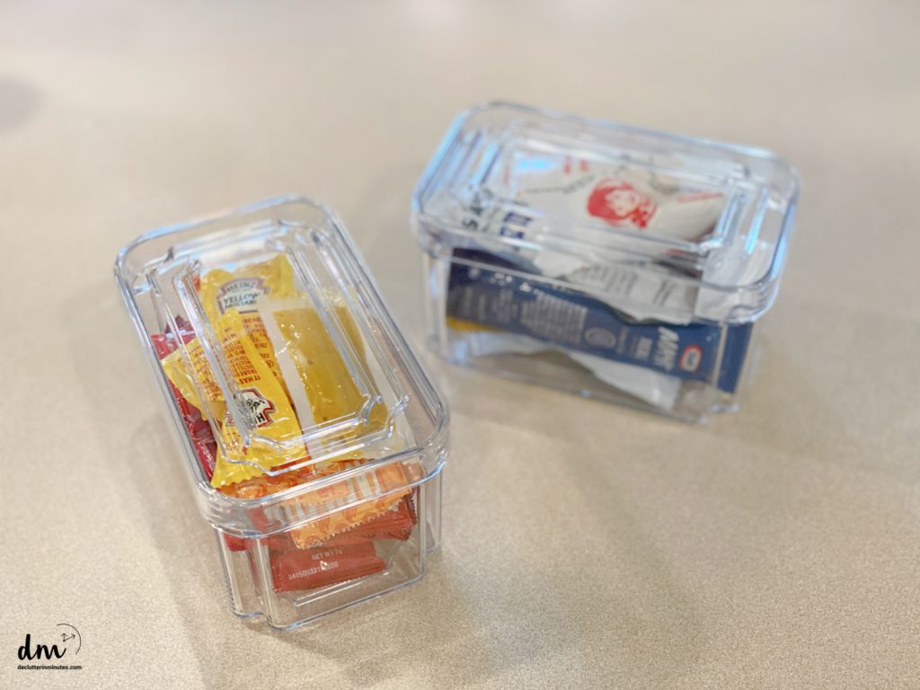 condiments in plastic bins on a counter