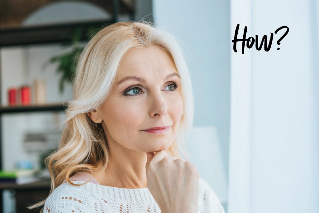 a midlife woman with blonde hair thinking