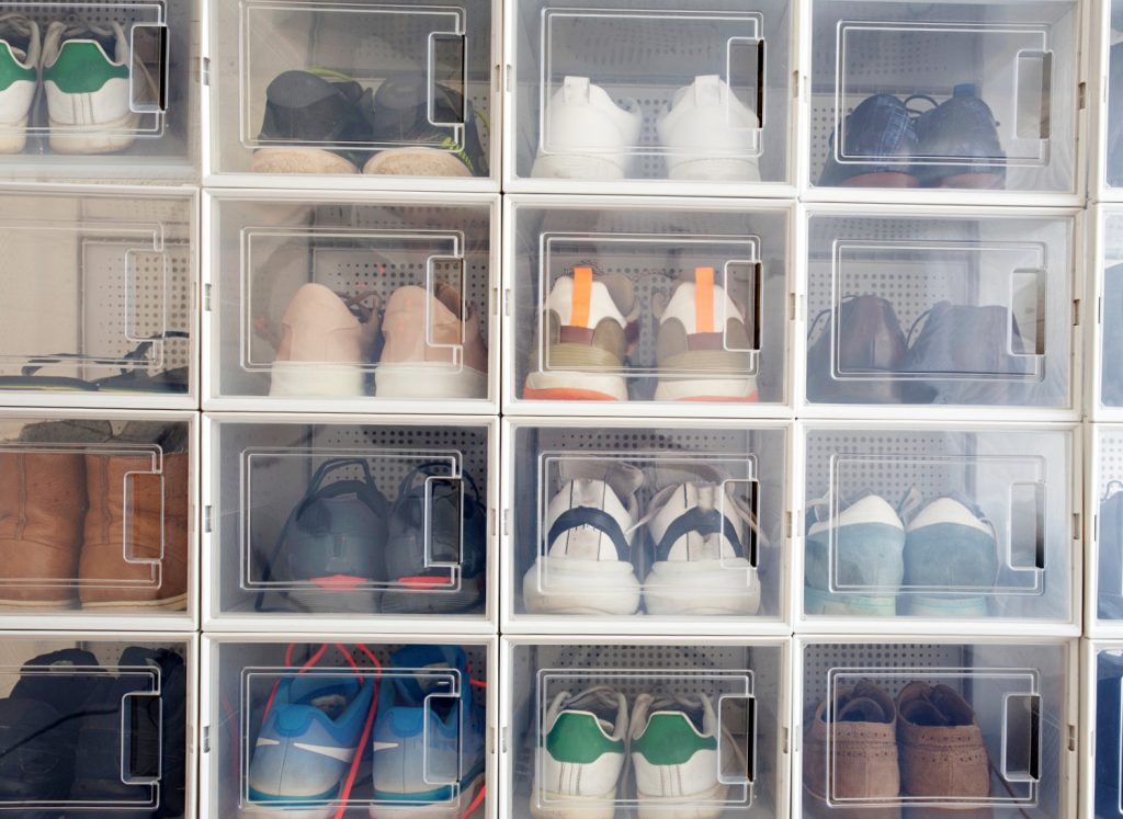 shoes in clear stackable containers in a closet