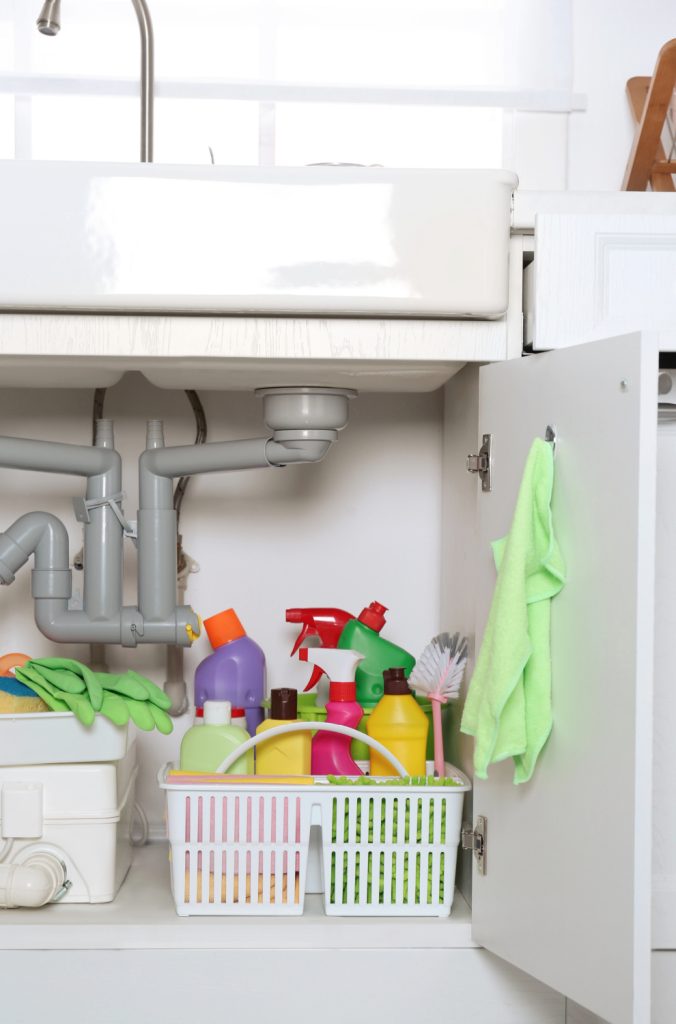 a cleaning caddy under a kitchen sink