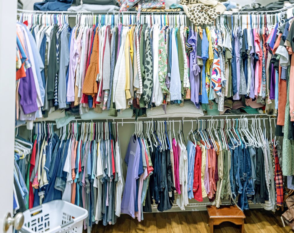 a closet full of hanging clothes