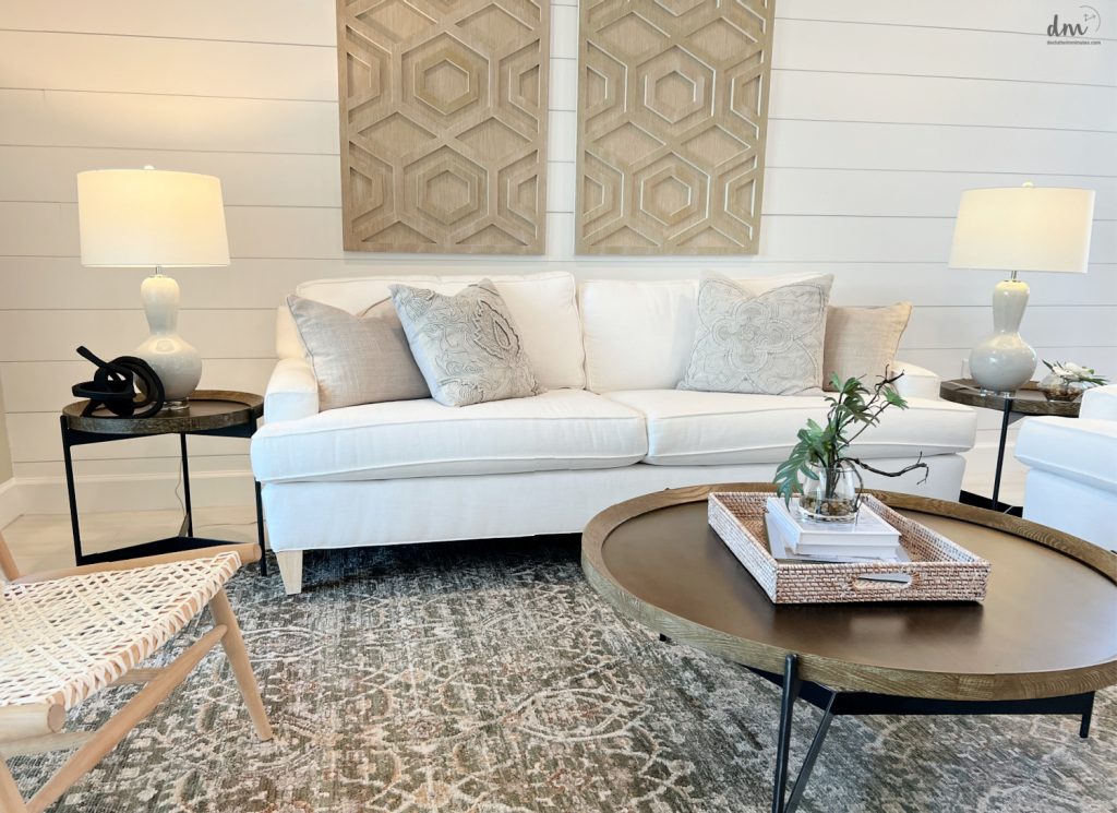 white couches in a family room with end tables