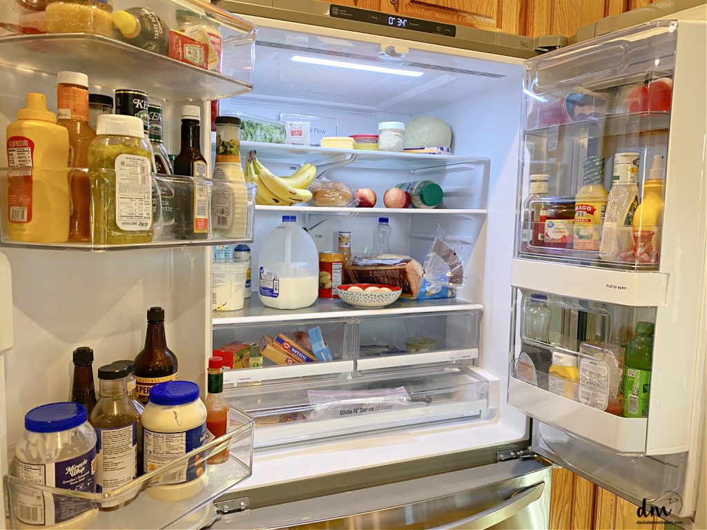 a somewhat cluttered and messy fridge