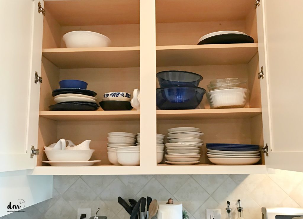 crowded cabinets filled with stacks of dishes