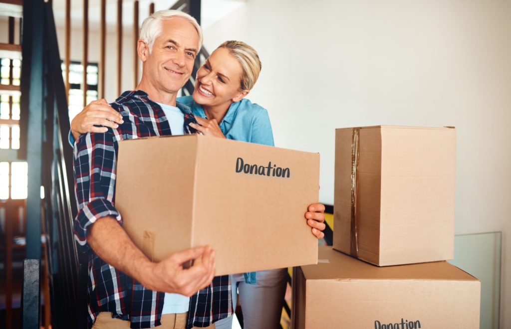 a woman happy looking at a husband holding a donation box