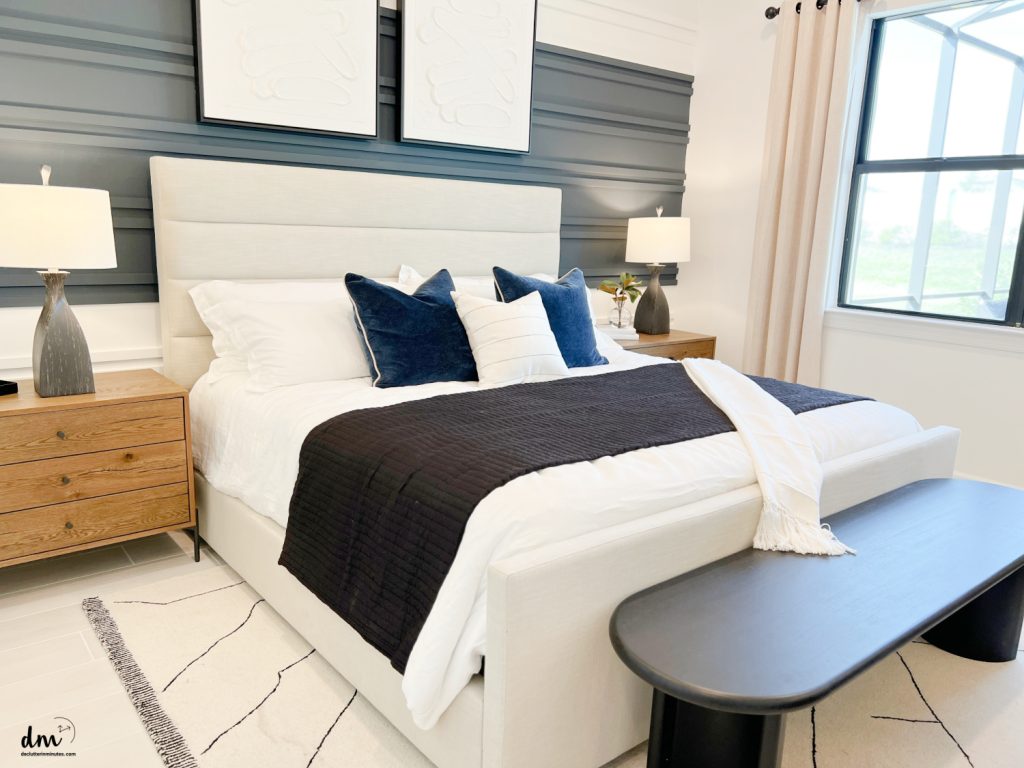 blue blanket on a white bed in a neat downsized bedroom