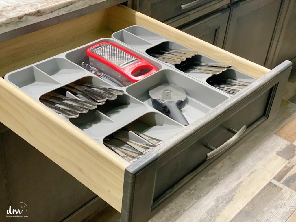 a neat and downsized silverware drawer in a kitchen