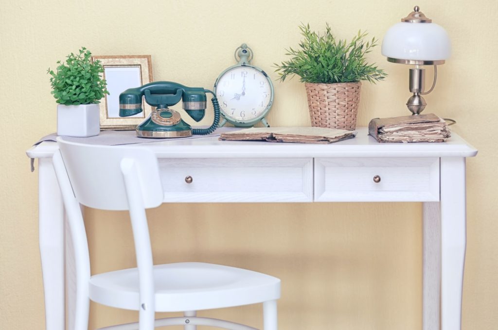 a white desk covered with inherited items