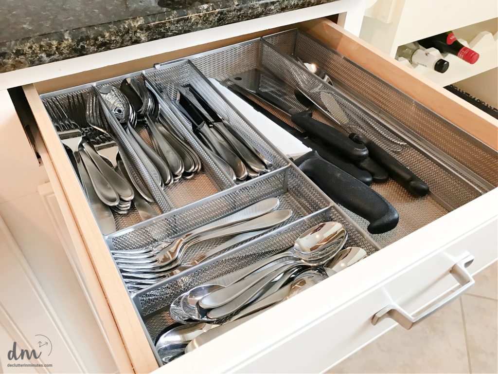 an opened silverware drawer in a kitchen
