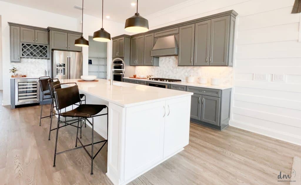 a neat and organized kitchen with a white peninsula