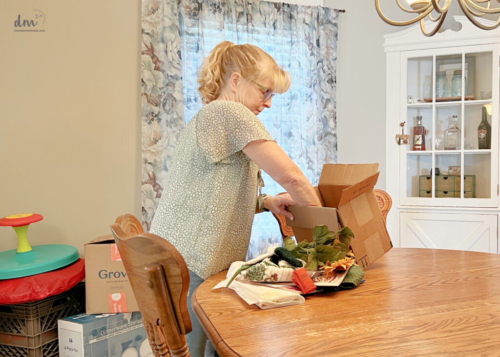 A WOMAN Putting donations into a box