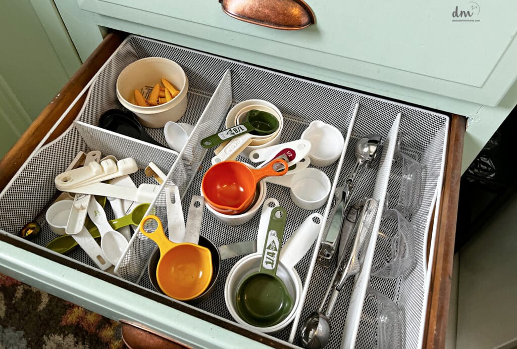 before of a overstuffed measuring cup drawer