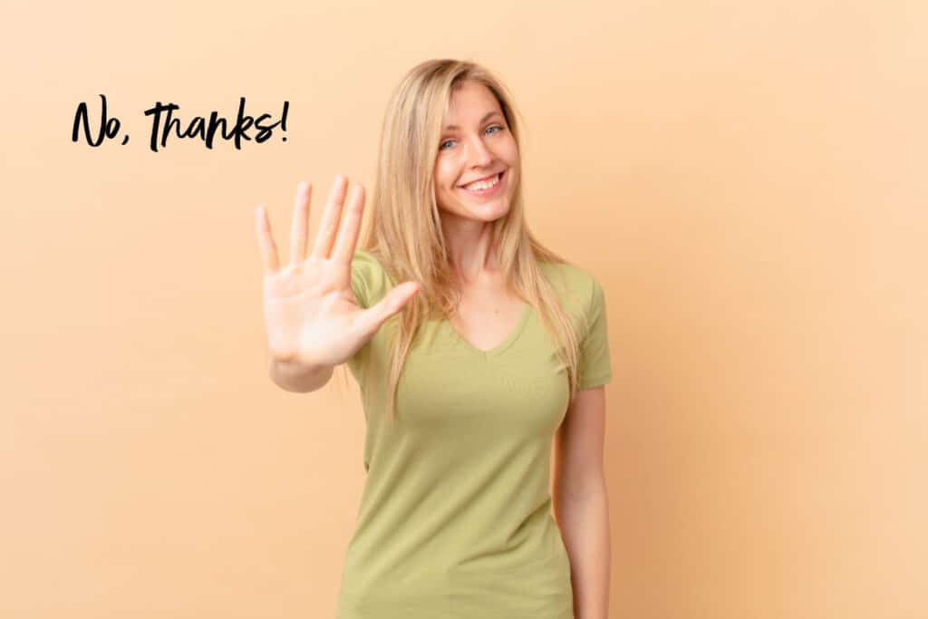 a woman with her hand out in a stop motion with the words NO THANKS 
